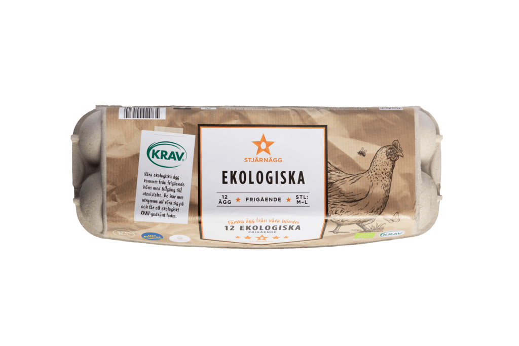En kartong med 12 ekologiska, frigående ägg märkta Ekologiska med en illustration av en kyckling. På förpackningen finns KRAV-certifieringen och andra kvalitetsmärken på en brun bakgrund.